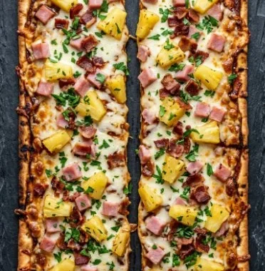 BBQ Hawaiian flatbread pizzas topped with pineapple and BBQ sauce