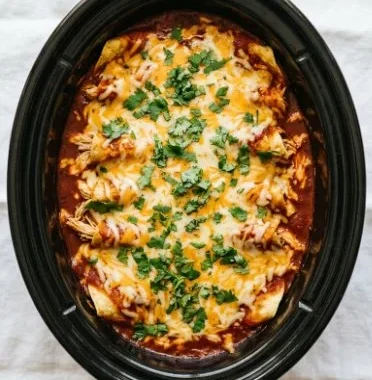 Crockpot Chicken Enchiladas served on a plate with toppings