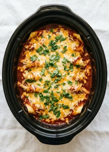 Crockpot Chicken Enchiladas served on a plate with toppings