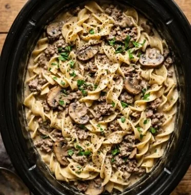 Slow Cooker Hamburger Stroganoff with creamy sauce and pasta served in a bowl