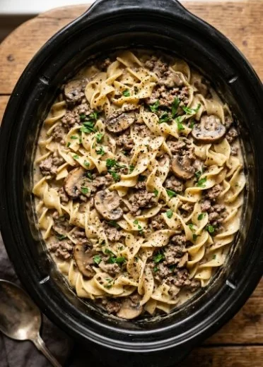 Slow Cooker Hamburger Stroganoff with creamy sauce and pasta served in a bowl