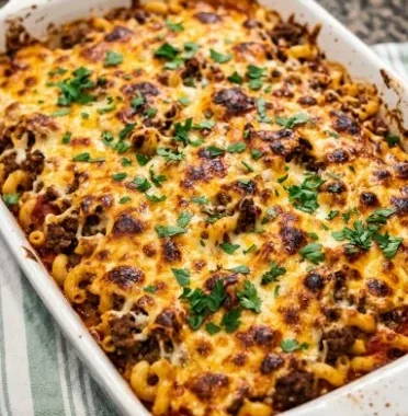 Delicious Beef Stroganoff Casserole topped with creamy sauce and beef served in a baking dish.