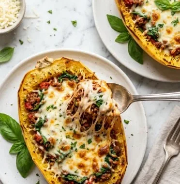 Cheesy lasagna boats filled with rich meat and cheese, garnished with herbs