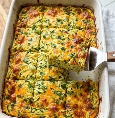 Cheesy Shredded Zucchini Casserole 1 Delicious cheesy shredded zucchini casserole served in a baking dish