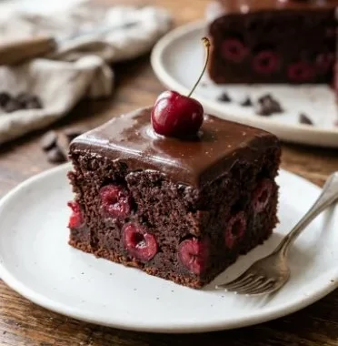 Delicious Chocolate Cherry Cake with rich chocolate frosting and cherry topping