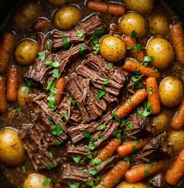 Crockpot Chuck Roast with Vegetables 1 Crockpot chuck roast with colorful vegetables in a rich sauce