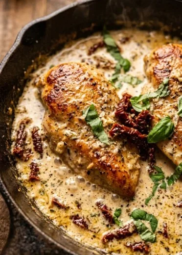 Delicious Easy Marry Me Chicken recipe served with herbs and creamy sauce.