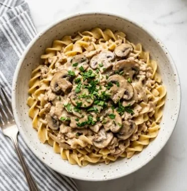 Ground Chicken Mushroom Stroganoff 1 Ground Chicken Mushroom Stroganoff served in a bowl with fresh herbs