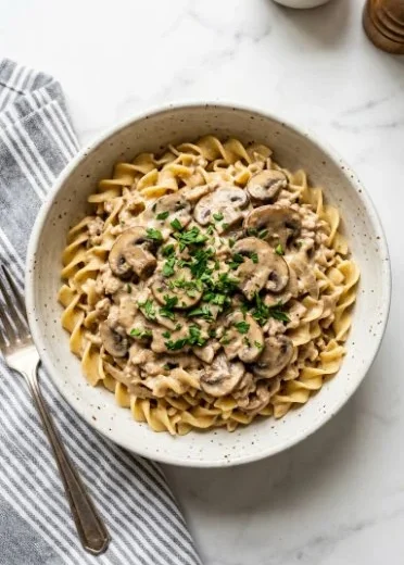 Ground Chicken Mushroom Stroganoff served in a bowl with fresh herbs