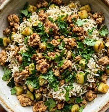 Delicious ground chicken zucchini rice skillet cooked in a pan