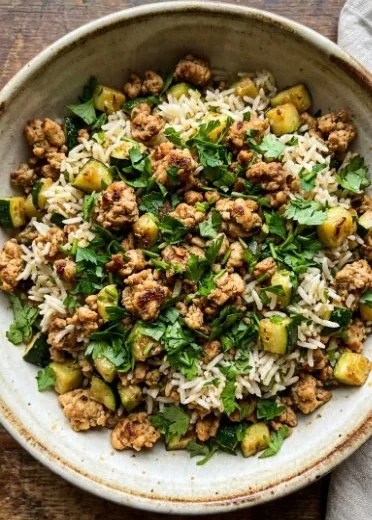 Delicious ground chicken zucchini rice skillet cooked in a pan
