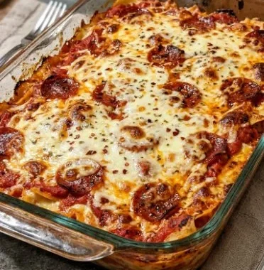 Keto Pizza Casserole 2 Delicious Keto Pizza Casserole served in a baking dish with cheese and toppings