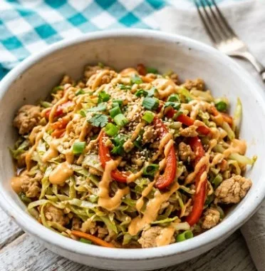 Keto Thai Chicken Cabbage Skillet served in a skillet with fresh vegetables