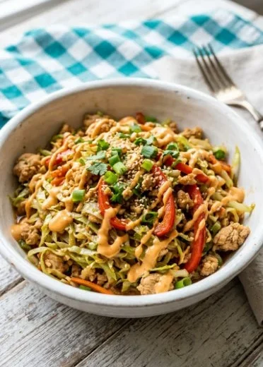 Keto Thai Chicken Cabbage Skillet served in a skillet with fresh vegetables