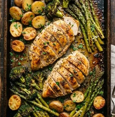 Sheet pan garlic butter chicken served with colorful veggies