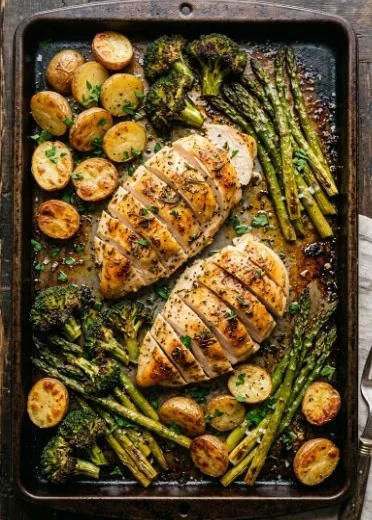 Sheet pan garlic butter chicken served with colorful veggies