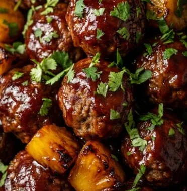 Slow cooker pineapple barbecue meatballs served in a dish
