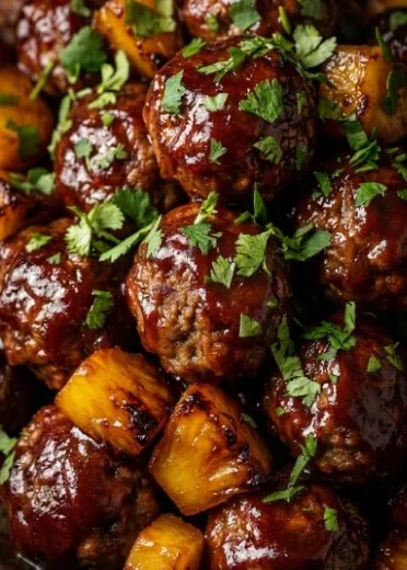 Slow cooker pineapple barbecue meatballs served in a dish
