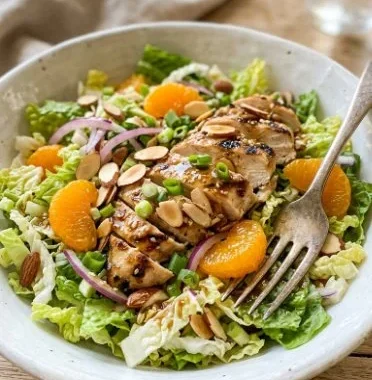 Asian Sesame Chicken Salad 1 A vibrant bowl of Asian sesame chicken salad with fresh vegetables and sesame dressing.
