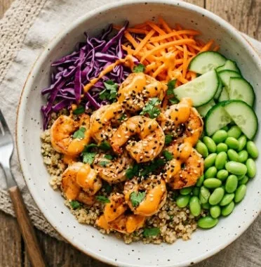 Bang Bang Shrimp Bowls featuring crispy shrimp in a spicy sauce with fresh garnishes