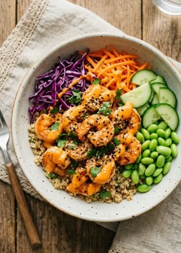 Bang Bang Shrimp Bowls featuring crispy shrimp in a spicy sauce with fresh garnishes