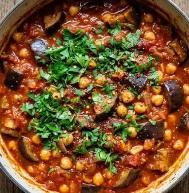 Braised harissa eggplant with chickpeas served in a bowl