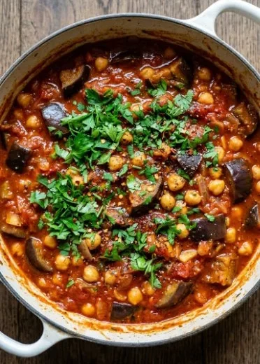 Braised harissa eggplant with chickpeas served in a bowl