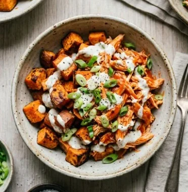 Buffalo Chicken Sweet Potato Casserole 1 Delicious Buffalo Chicken Sweet Potato Casserole topped with cheese and fresh herbs