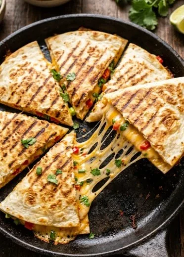 Delicious cheese quesadilla served with salsa and guacamole