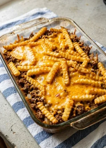Cheeseburger French fry bake topped with cheese and crispy fries