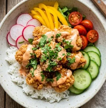 Crispy Bang Bang Chicken and Rice Bowls 1 Crispy Bang Bang Chicken served in a colorful rice bowl
