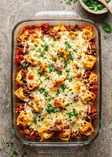 Delicious Dump and Bake Tortellini Casserole ready to serve in a baking dish