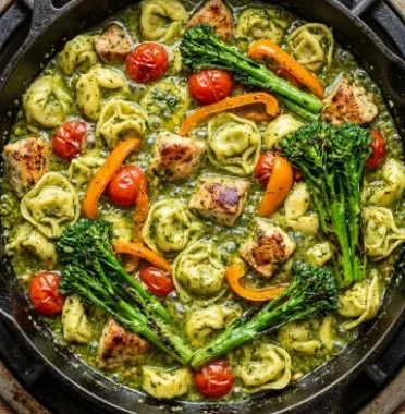 Easy Pesto Chicken Tortellini Veggies 2 Easy pesto chicken tortellini with fresh vegetables on a plate.