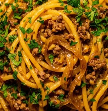 Plate of Garlic Butter Beef Pasta garnished with parsley