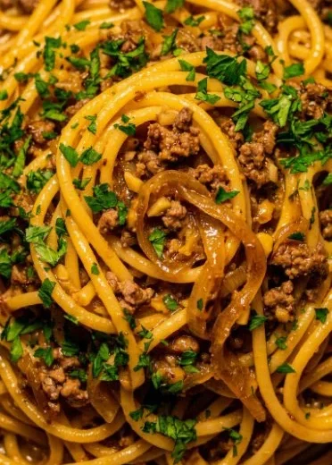 Plate of Garlic Butter Beef Pasta garnished with parsley