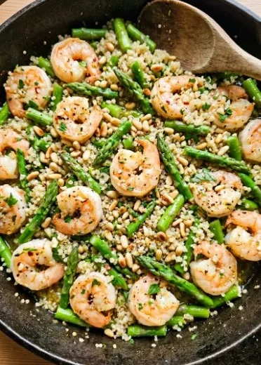 Plate of Garlic Butter Shrimp served with quinoa and asparagus