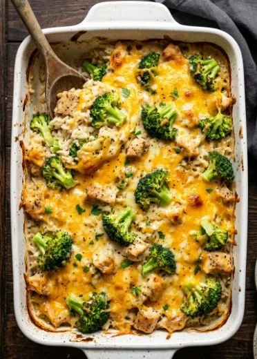 High-protein chicken broccoli rice casserole topped with melted cheese