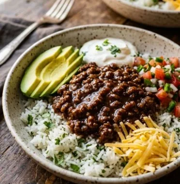 Delicious Lazy Ground Beef Taco Bowls topped with fresh ingredients.
