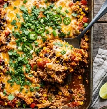 Delicious Mexican Chicken Casserole topped with cheese and colorful vegetables.