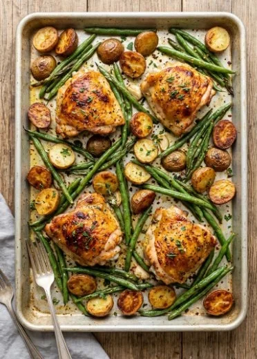 Parmesan Garlic Chicken thighs with potatoes and green beans on a plate