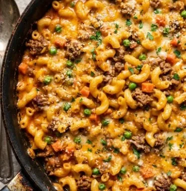 Delicious Shipwreck Hamburger Casserole topped with melted cheese and vegetables.