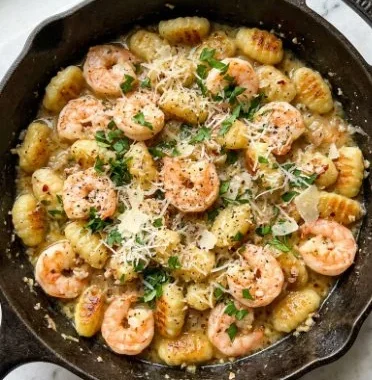 Shrimp and Gnocchi with Garlic Parmesan 2 Shrimp and Gnocchi with Garlic Parmesan served in a creamy sauce