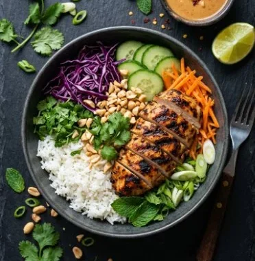 Thai Peanut Chicken Buddha Bowl 1 Thai Peanut Chicken Buddha Bowl with colorful veggies and rice