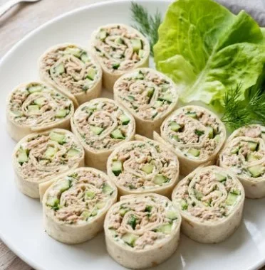 Tuna Pinwheels 1 Delicious tuna pinwheels served on a plate with a garnish