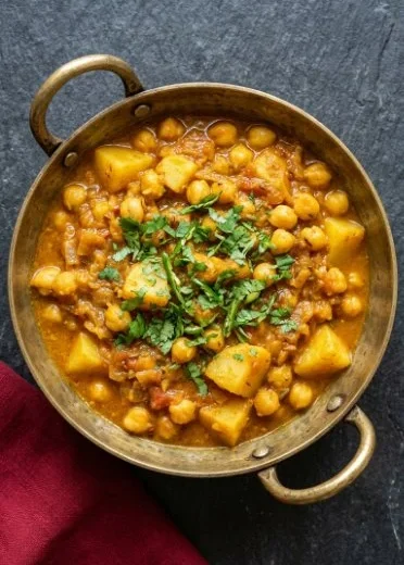 Delicious vegan potato and chickpea curry served in a bowl