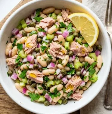 White Bean Salad with Tuna 1 White bean salad with tuna served in a bowl, healthy and delicious meal option.