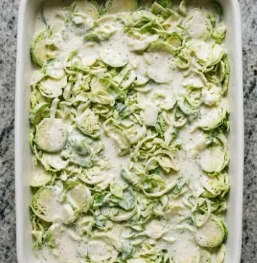Brussels Sprouts Gratin (Low-Carb, Gluten-Free) 1 Baked Brussels Sprouts Gratin topped with cheese in a white dish