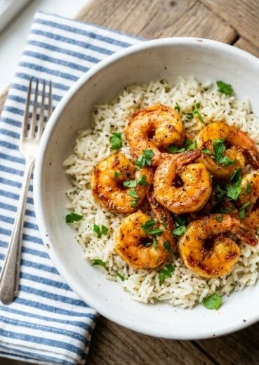 Delicious Cajun shrimp served over fluffy buttery rice dish
