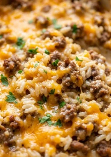 Cheesy ground beef and rice casserole served in a baking dish