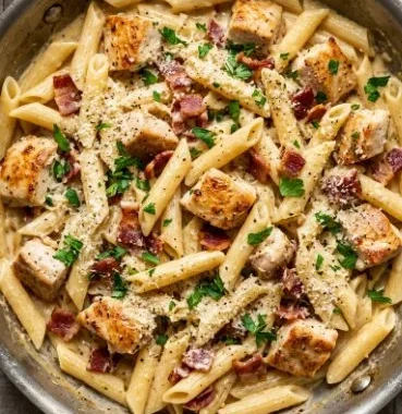 Creamy Chicken Pasta 2 Delicious creamy chicken pasta served in a bowl with herbs